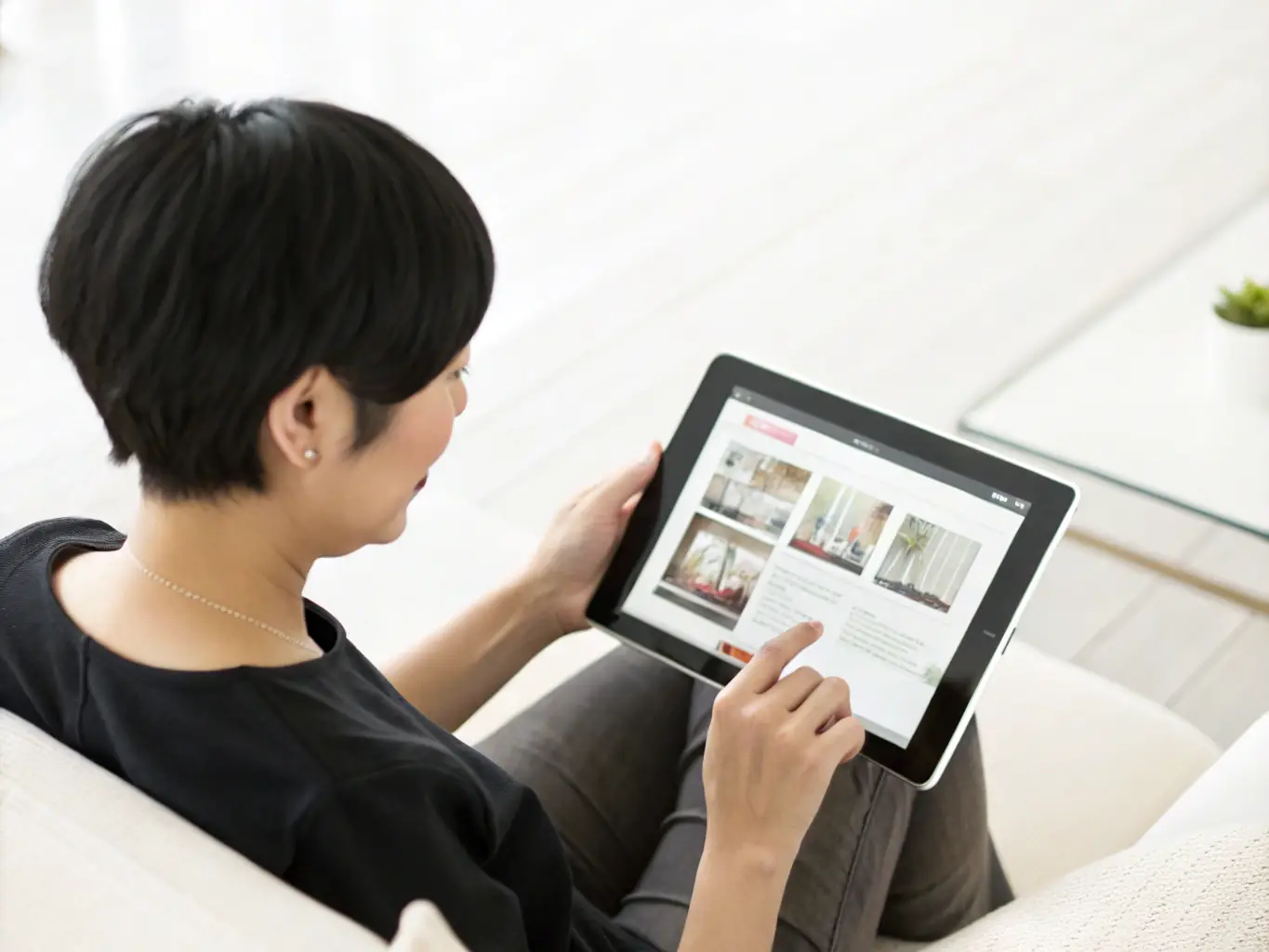 A user interacting with a website on a tablet, highlighting the intuitive navigation and engaging content that VISUAL MEDIA designs to improve user experience.